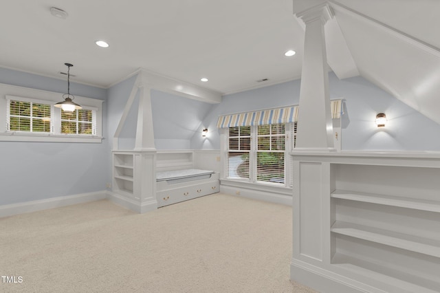 spacious closet with light colored carpet and vaulted ceiling