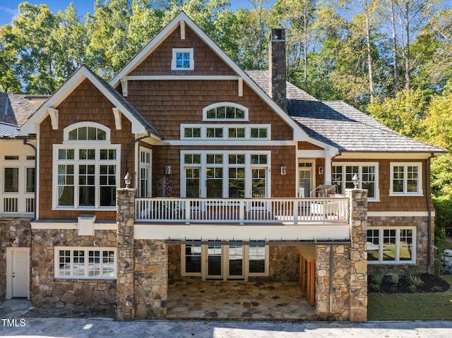 rear view of house with a wooden deck