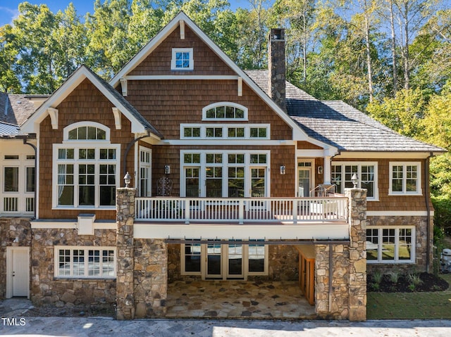 3105 Cone Manor Ln, Raleigh, NC 27613 - rear view of property with a chimney, stone siding, and a wooden deck