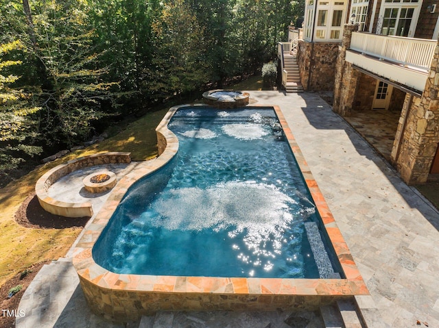 view of swimming pool featuring a patio area and an outdoor fire pit