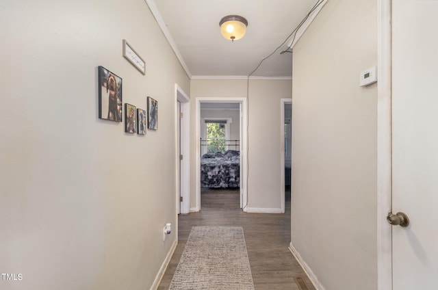 hall with ornamental molding and dark hardwood / wood-style floors