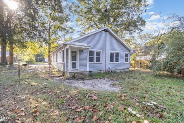 rear view of property with a lawn