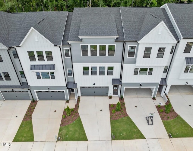 4505 Mint Leaf Ln, Raleigh, NC 27612 - view of front of home featuring board and batten siding, roof with shingles, an attached garage, and driveway