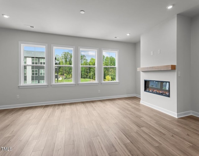 4505 Mint Leaf Ln, Raleigh, NC 27612 - unfurnished living room featuring healthy amount of natural light, wood finished floors, baseboards, and recessed lighting