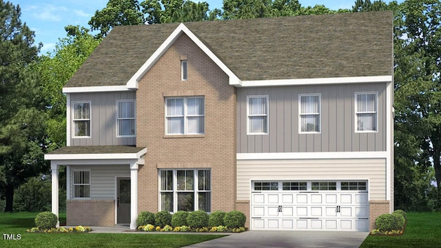 view of front of home with a garage and a front lawn