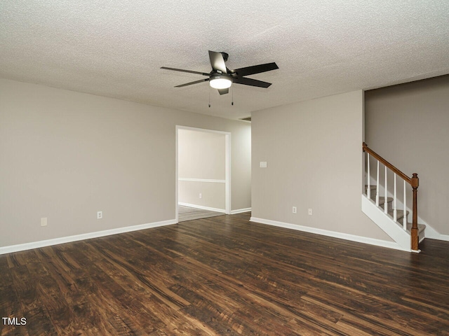 unfurnished room with a textured ceiling, dark hardwood / wood-style floors, and ceiling fan