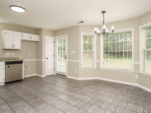 kitchen featuring dishwasher, a textured ceiling, a notable chandelier, white cabinetry, and hanging light fixtures