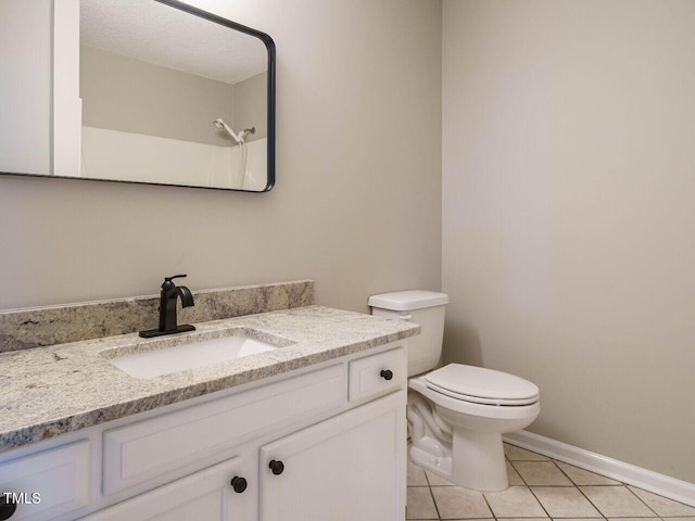 bathroom featuring vanity, toilet, and tile patterned floors