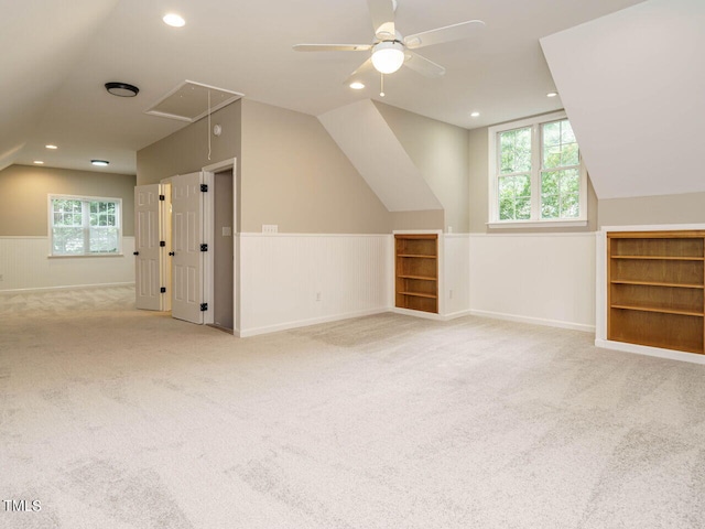 additional living space featuring vaulted ceiling, ceiling fan, and light carpet