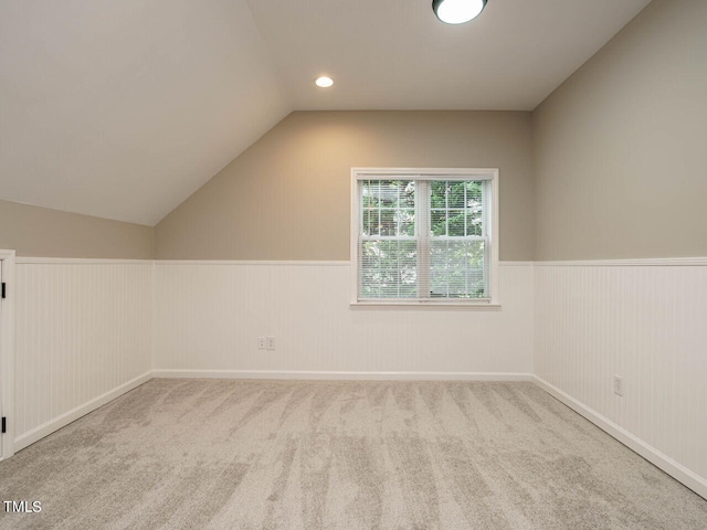 additional living space with carpet and vaulted ceiling