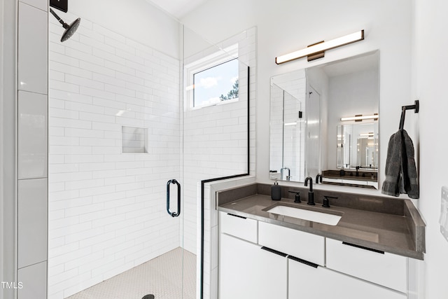 bathroom with vanity and a shower with shower door