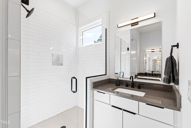 bathroom featuring a shower stall and vanity