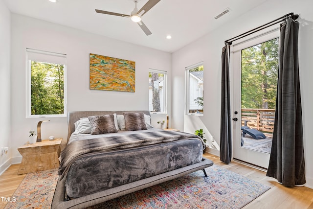 bedroom with ceiling fan, light hardwood / wood-style flooring, and access to outside