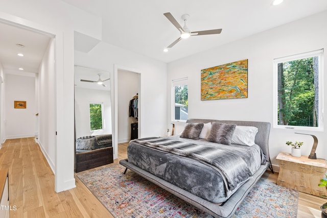 bedroom with light wood-style flooring, recessed lighting, and multiple windows