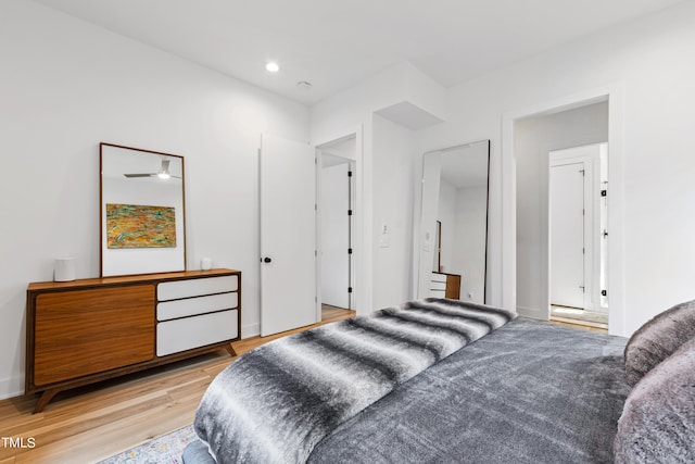 bedroom with light wood-style flooring, baseboards, and recessed lighting