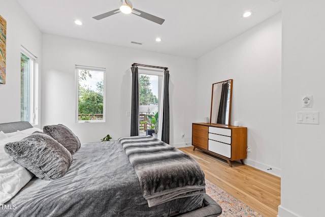 bedroom featuring recessed lighting, light wood-type flooring, a ceiling fan, and multiple windows