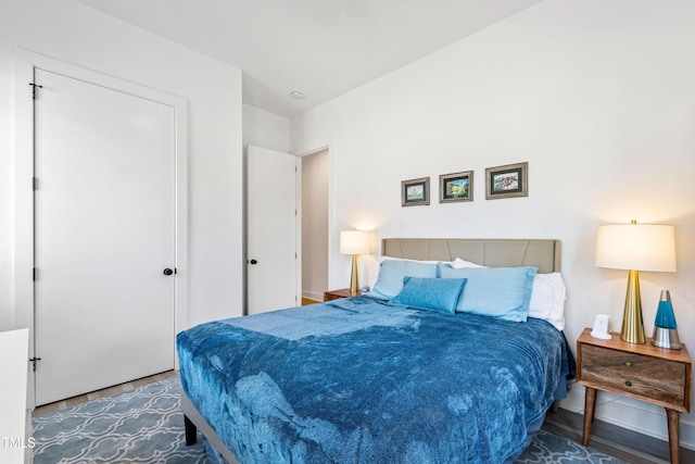 bedroom featuring wood finished floors and baseboards