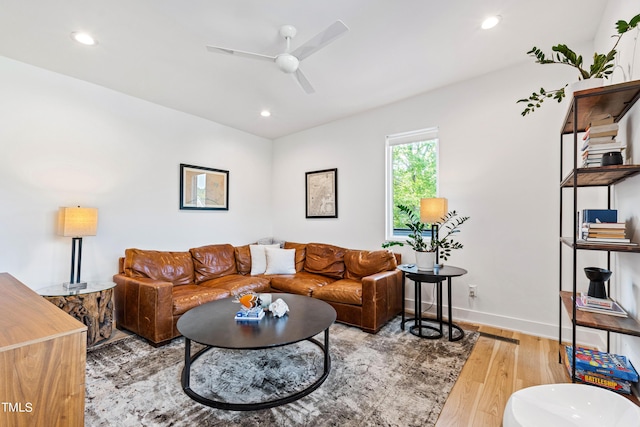 living area with a ceiling fan, recessed lighting, baseboards, and light wood-type flooring
