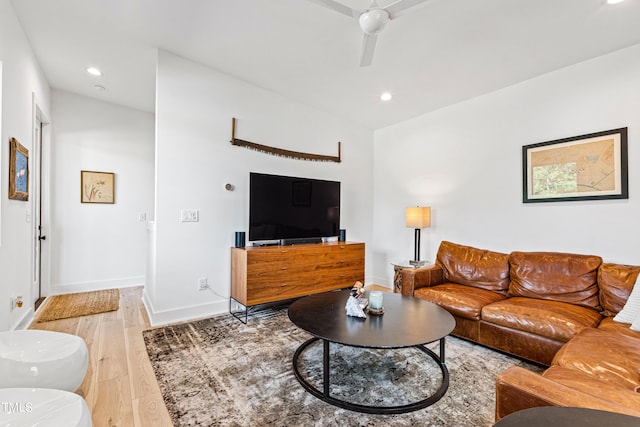 living room featuring light wood finished floors, baseboards, a ceiling fan, and recessed lighting