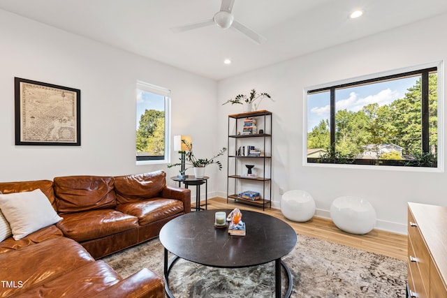living area with baseboards, ceiling fan, light wood-style flooring, and recessed lighting
