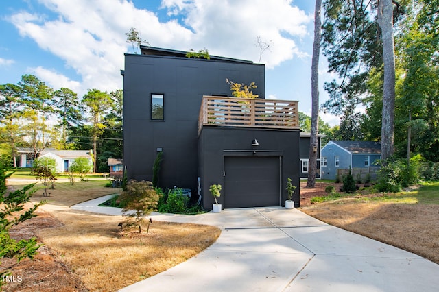 modern home with a balcony and a garage