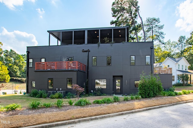 back of property featuring stucco siding and a balcony