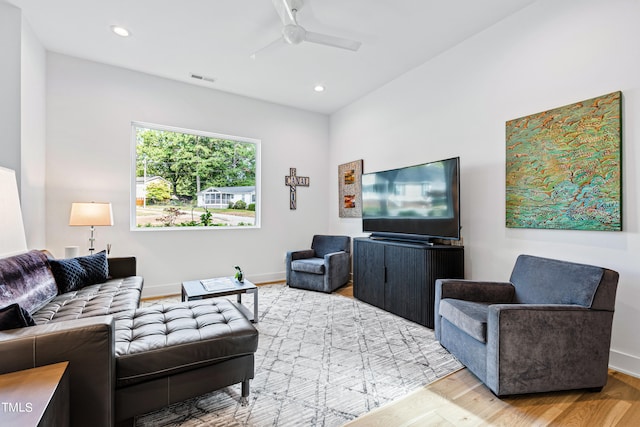 living room with hardwood / wood-style floors and ceiling fan