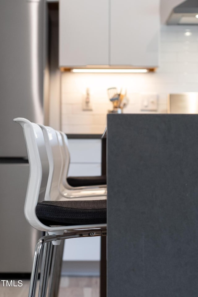 interior details featuring wall chimney range hood