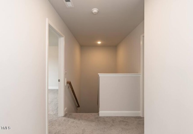 corridor featuring light colored carpet