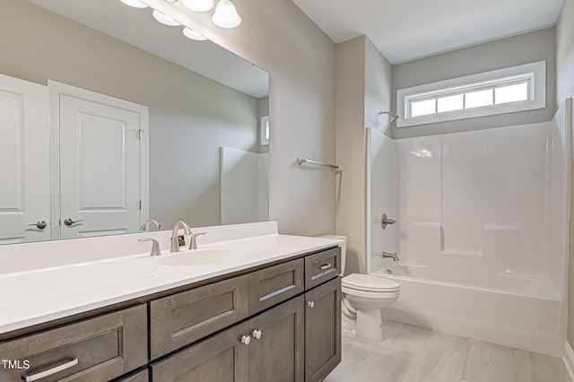 full bathroom with vanity, toilet, and washtub / shower combination