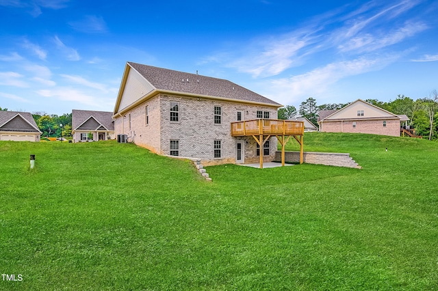 back of property with a lawn and a patio area