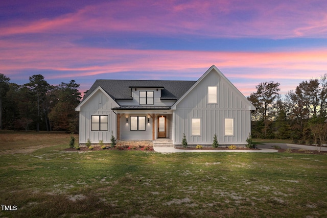 modern inspired farmhouse featuring a porch and a yard