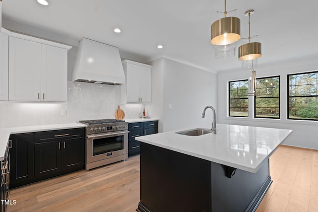 kitchen with white cabinetry, pendant lighting, sink, stainless steel range, and custom exhaust hood