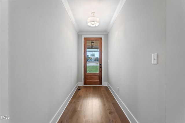 entryway with ornamental molding and hardwood / wood-style flooring