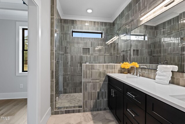 bathroom with wood-type flooring, vanity, a shower with door, and crown molding