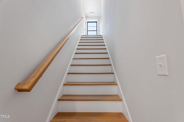 stairs with hardwood / wood-style flooring