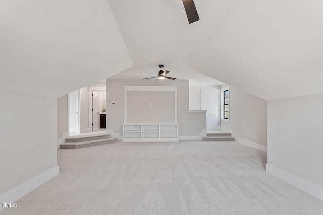 additional living space featuring ceiling fan, light colored carpet, and lofted ceiling