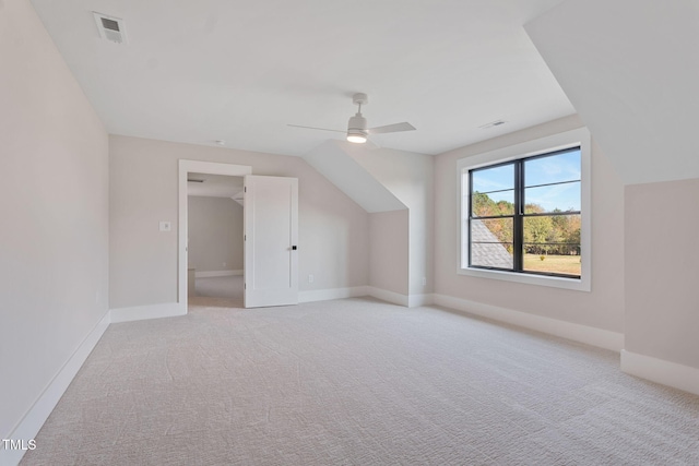 bonus room with ceiling fan, light colored carpet, and lofted ceiling