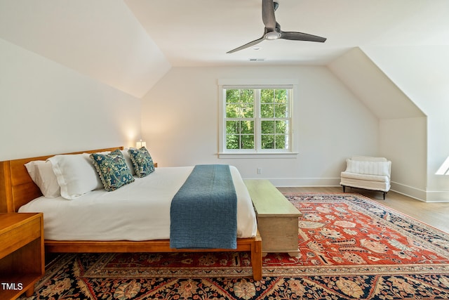 bedroom featuring ceiling fan, vaulted ceiling, and hardwood / wood-style floors