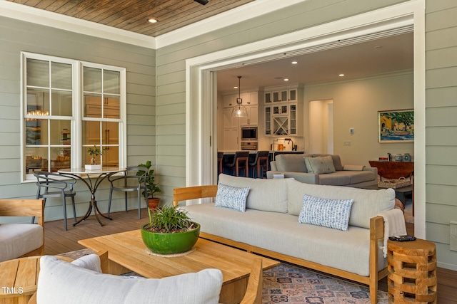 living room featuring crown molding and hardwood / wood-style floors