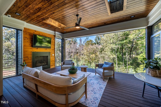 sunroom / solarium with wood ceiling, a healthy amount of sunlight, and a skylight