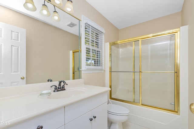 full bathroom featuring toilet, vanity, and shower / bath combination with glass door