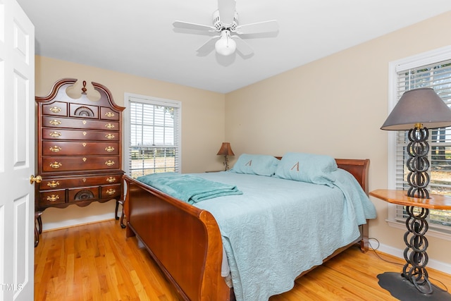 bedroom with ceiling fan and light hardwood / wood-style floors