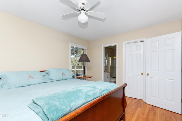 bedroom featuring ensuite bathroom, light wood-type flooring, and ceiling fan