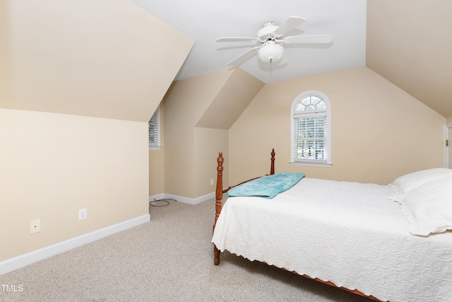 bedroom with lofted ceiling, light colored carpet, and ceiling fan