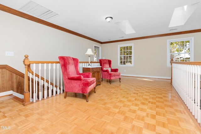 living area with crown molding, light parquet floors, and wood walls