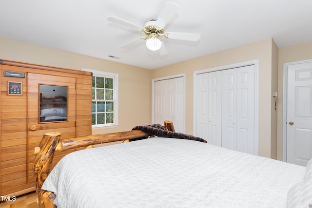 bedroom featuring two closets and ceiling fan