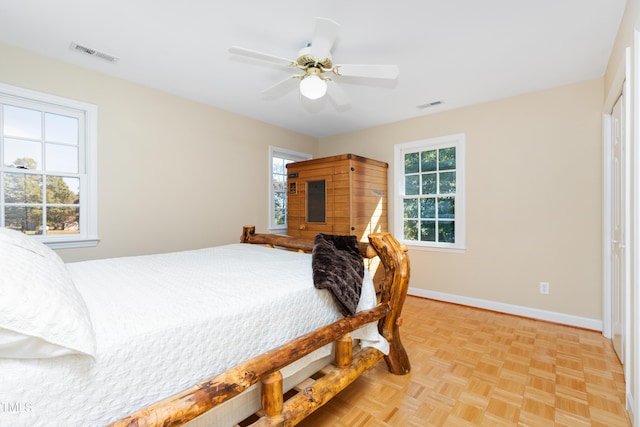 bedroom with light parquet flooring and ceiling fan