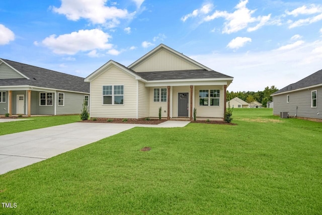 view of front of home with cooling unit and a front yard