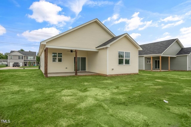 back of house with ceiling fan, a yard, and a patio